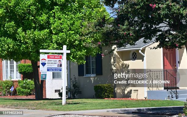 For Sale sign is posted in front of a home for sale in San Marino, California on September 6, 2023. With US mortgage rates rising to 15-year highs...