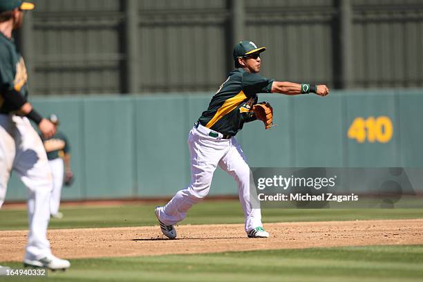 Hiroyuki Nakajima of the Oakland Athletics fields during a spring training game against the Colorado Rockies at Phoenix Municipal Stadium on March 2,...