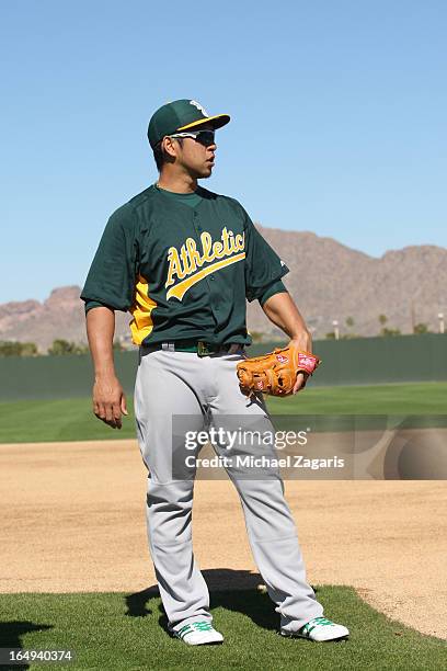 Hiroyuki Nakajima of the Oakland Athletics stands on the field during a spring training workout at Papago Park on February 17, 2013 in Phoenix,...