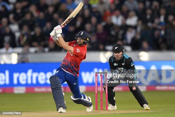 England batsman Dawid Malan hits out watched by wicketkeeper Tim Seifert during the 1st Vitality T20 I match between England and New Zealand at...