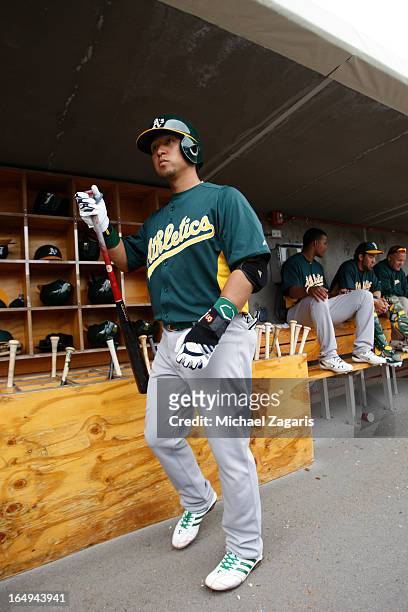 Hiroyuki Nakajima of the Oakland Athletics stands in the dugout during a spring training game against the Colorado Rockies at Salt River Fields at...