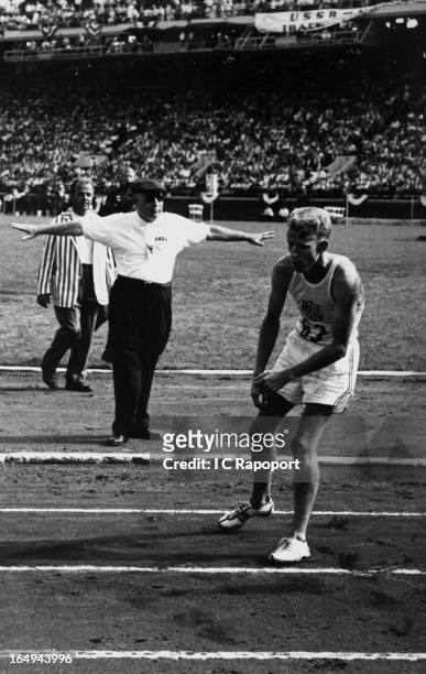 Meter runner Bob Soth collapses with only three laps to go during the USA versus the USSR track meet at Franklin Field on June 18, 1959 in...