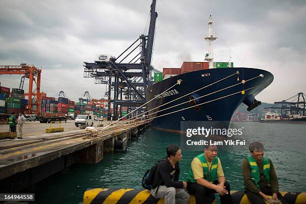 Striking dockers sit on the quayside at the Kwai Chung Container Terminal on March 29, 2013 in Hong Kong, China. Over 100 workers, who are employed...