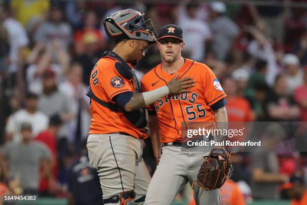 Ryan Pressly and Martin Maldonado of the Houston Astros celebrate after defeating the Boston Red Sox at Fenway Park on August 30, 2023 in Boston,...