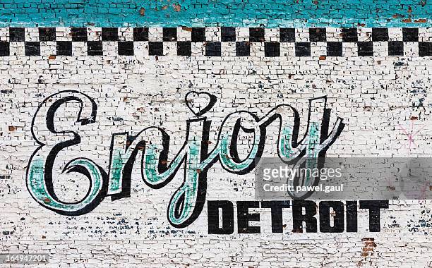 enjoy detroit sign on wall - detroit michigan stock pictures, royalty-free photos & images