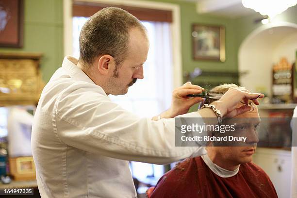 barber cutting mans hair - haircut stock pictures, royalty-free photos & images
