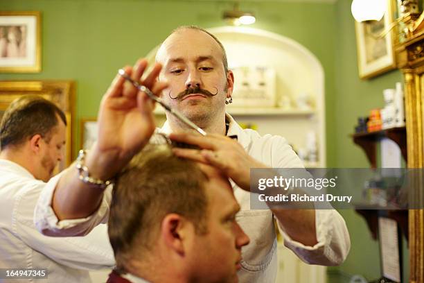 barber cutting customers hair - barber shop fotografías e imágenes de stock