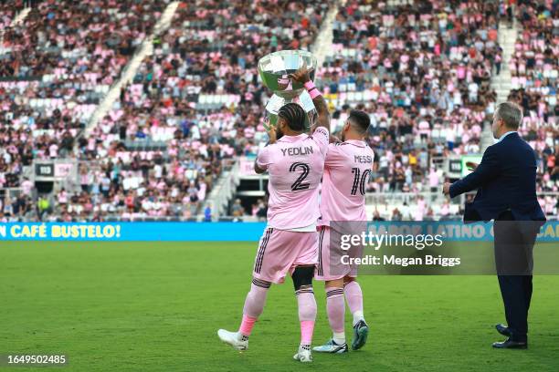 DeAndre Yedlin and Lionel Messi of Inter Miami CF walk with the Leagues Cup trophy prior to a match between Nashville SC and Inter Miami CF at DRV...