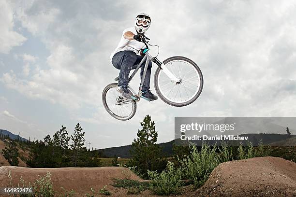 guy jumping at a bike park. - bicycle stunt stock pictures, royalty-free photos & images