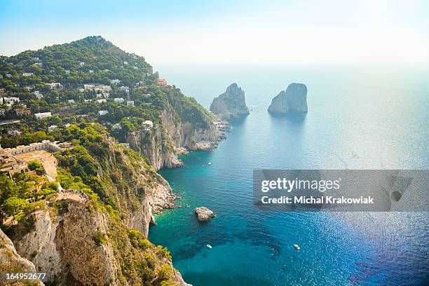 faraglioni rocks - natural landmark of capri island in italy. - a capri stock pictures, royalty-free photos & images