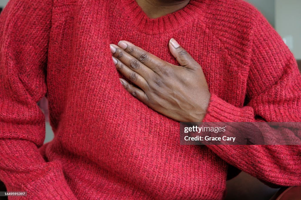 Woman Holds Her Chest in Pain