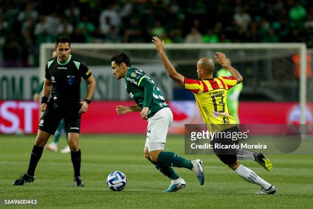 Raphael Veiga of Palmeiras fights for the ball with Juan Pablo of Deportivo Pereira during a second leg quarter final match between Palmeiras and...