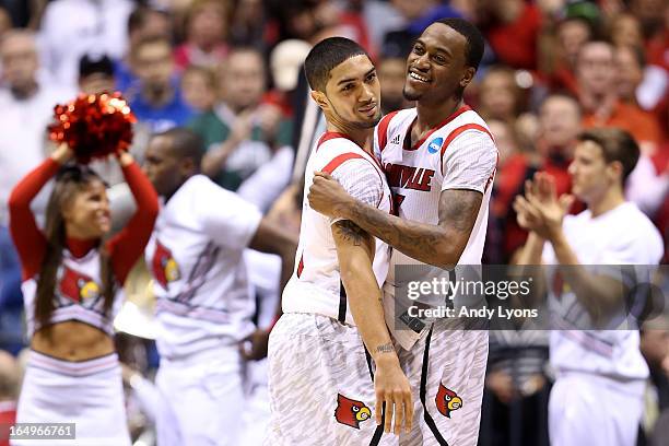 Russ Smith and Kevin Ware of the Louisville Cardinals celebrate after they won 77-69 against the Oregon Ducks during the Midwest Region Semifinal...