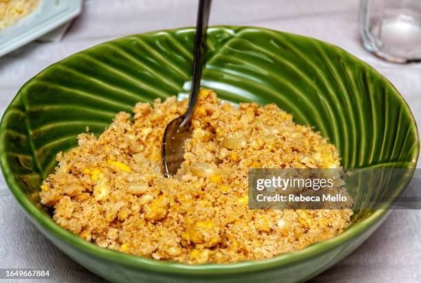 seen from above, a green bowl of farofa with eggs and onion, a side dish for brazilian feijoada. - brazilian feijoada dish stock-fotos und bilder