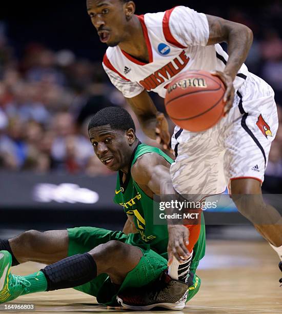 Louisville guard Russ Smith tries to get past Oregon guard Damyean Dotson in second half action in their NCAA fourth round game on Friday, March 29...