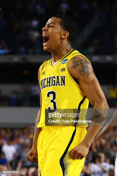 Trey Burke of the Michigan Wolverines reacts after shooting a game tying three pointer in the final seconds of the second half againist the Kansas...