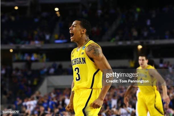 Trey Burke of the Michigan Wolverines reacts after shooting a game tying three pointer in the final seconds of the second half againist the Kansas...