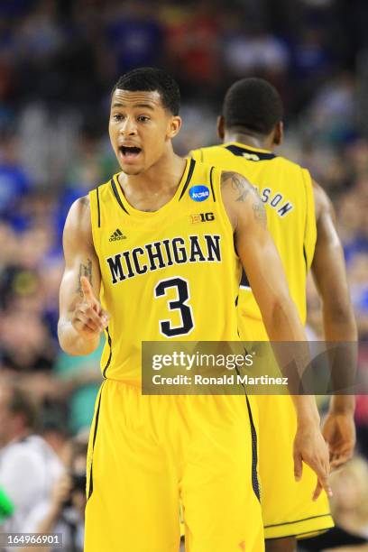 Trey Burke of the Michigan Wolverines celebrates during overtime against the Kansas Jayhawks during the South Regional Semifinal round of the 2013...