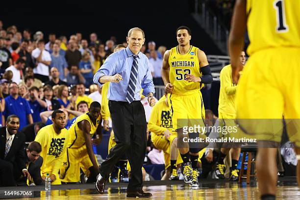 Head coach John Beilein of the Michigan Wolverines celebrates late in their 87 to 85 win over the Kansas Jayhawks in overtime during the South...