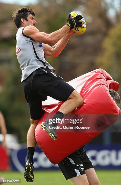 Quinten Lynch of the Magpies marks during a Collingwood Magpies AFL training session at Gosch's Paddock on March 30, 2013 in Melbourne, Australia.