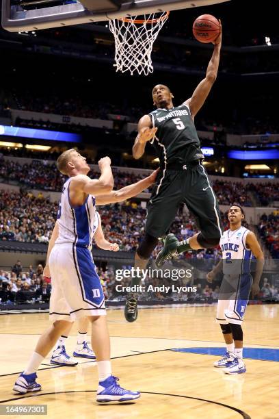 Adreian Payne of the Michigan State Spartans dunks in the first half against Mason Plumlee of the Duke Blue Devils during the Midwest Region...