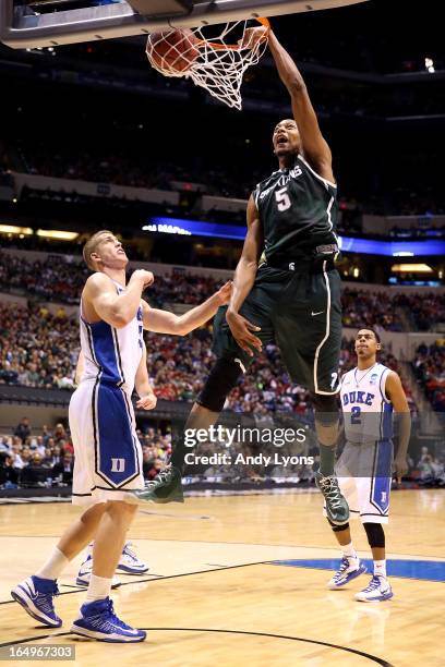 Adreian Payne of the Michigan State Spartans dunks in the first half against Mason Plumlee of the Duke Blue Devils during the Midwest Region...