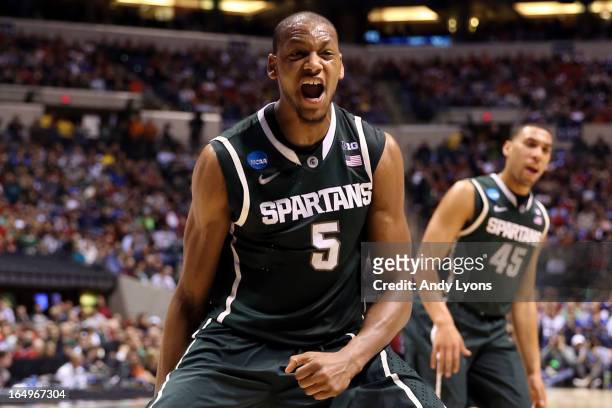 Adreian Payne of the Michigan State Spartans reacts after he dunked in the first half against the Duke Blue Devils during the Midwest Region...