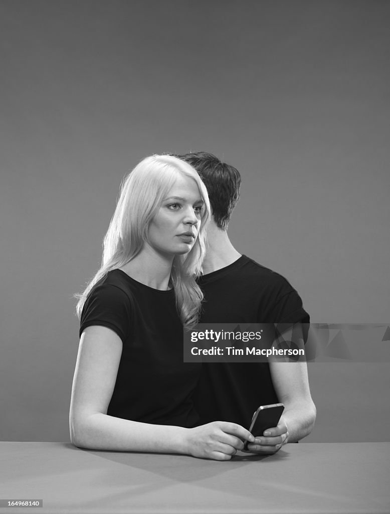 Girl and Boy hold a phone