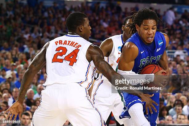 Sherwood Brown of the Florida Gulf Coast Eagles drives against Casey Prather of the Florida Gators in the first half during the South Regional...