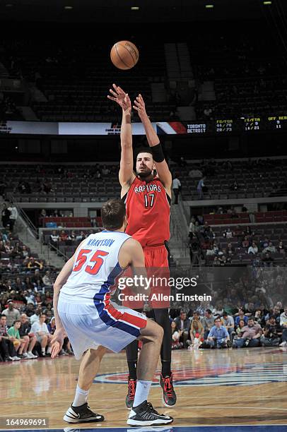 Jonas Valanciunas of the Toronto Raptors shoots the ball over Viacheslav Kravtsov of the Detroit Pistons during the game between the Detroit Pistons...