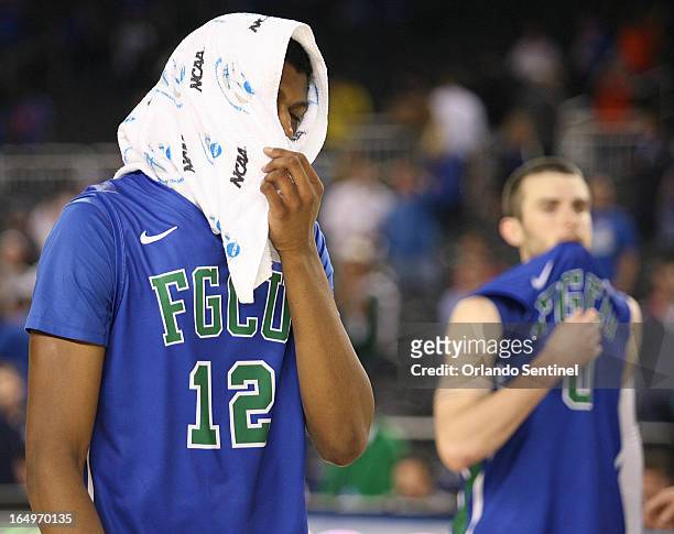 Florida Gulf Coast's Eric McKnight and Brett Comer are dejected after a 62-50 loss against Florida in the NCAA Tournament's Sweet 16 at Cowboys...