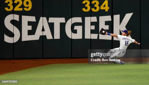 Travis Jankowski of the Texas Rangers catches a fly ball off the bat of Michael Brantley of the Houston Astros during the fifth inning at Globe Life...