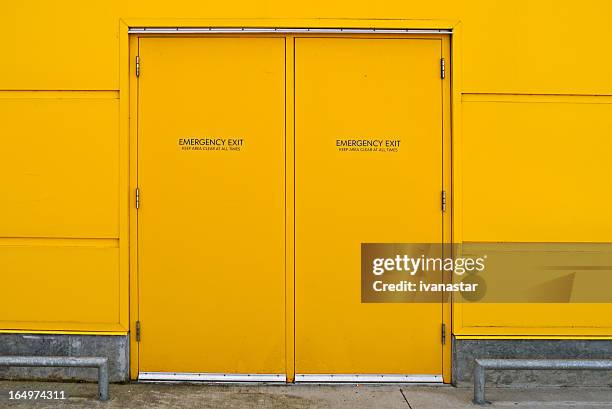 yellow industrial utility door - fire exit sign stock pictures, royalty-free photos & images
