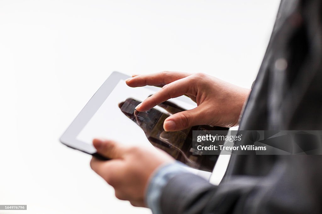 Hands working on a tablet computer
