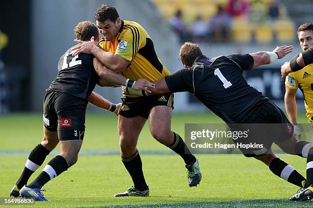 Ben May of the Hurricanes is tackled by Andries Strauss and Schalk Ferreira of the Kings during the round seven Super Rugby match between the...