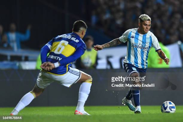 Juan Quintero of Racing fights for the ball with Marcos Rojo of Boca Juniors during a second leg quarter final match between Racing Club and Boca...