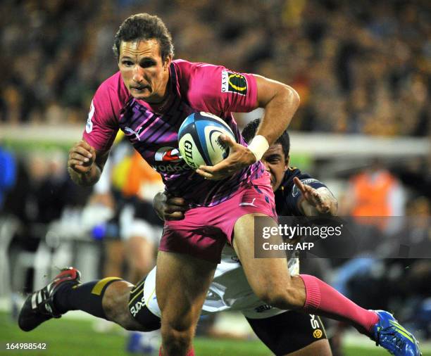 Petrus Visser of the Bulls is tackled by a Brumbies player during round 7 of the rugby Super 15 match in Canberra on March 30, 2013. The Brumbies won...