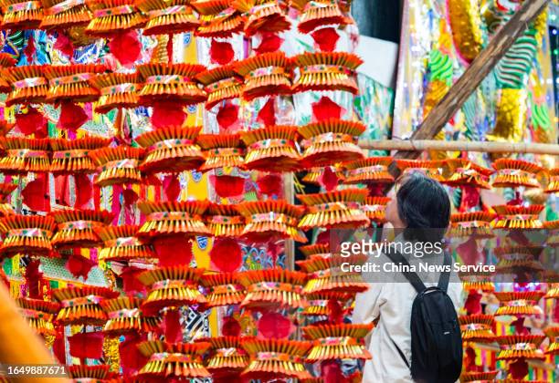 Citizen looks at paper offerings at King George V Memorial Park during Yulan Festival, also known as the Hungry Ghost Festival, on August 30, 2023 in...