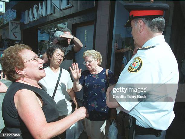 Chief Julian Fantino stops to chat with, l-r, Francesca Fenomeno, Carmela Danieli and Katerina Danieli on St Clair Avw. West. Later he wipes his brow...
