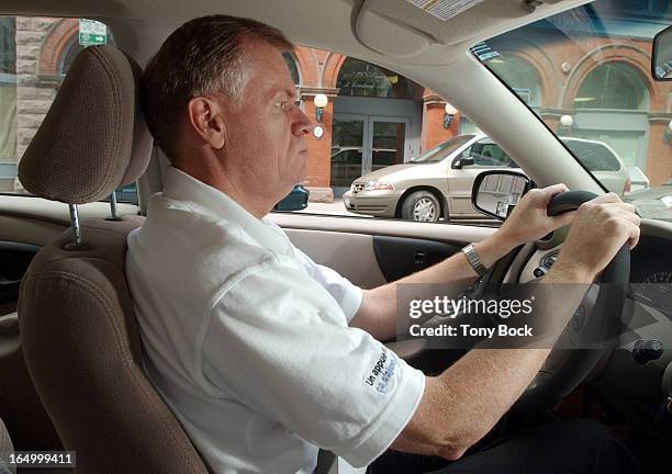 Staan Griffin, President and CEO, Insurance Bureau of Canada, demonstrates the correct way of using a headrest. TONY BOCK/TORONTO STAR