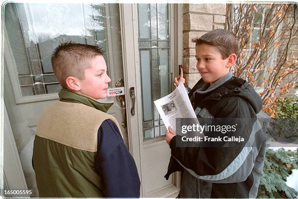Share a Life Campaign -- ADAM SAMMUT. 11, and his friend MATT YEROSCHENKO both in grade 6 at Sacred Heart Catholic School, Brampton, hand out a SHARE...