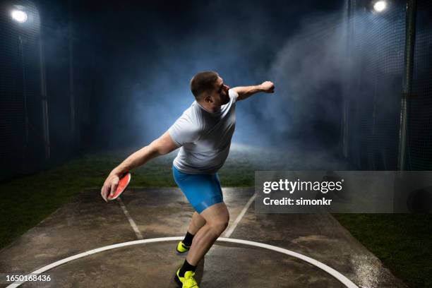 male athlete holding discuss - discus stock pictures, royalty-free photos & images