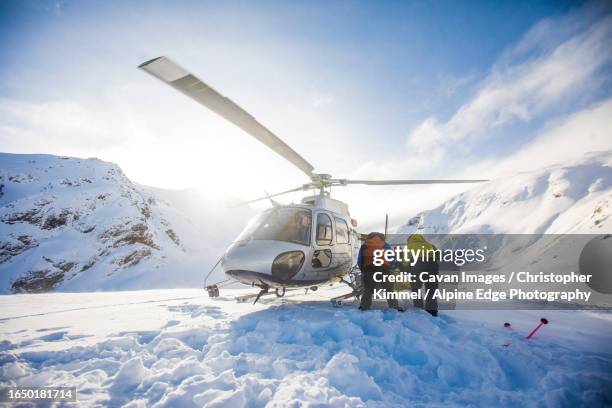 rear view of loading helicopter basket after trip into the mountains - helicopter landing stock pictures, royalty-free photos & images