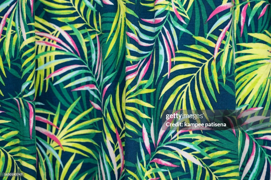 Green leaves seamless pattern background on fabric background