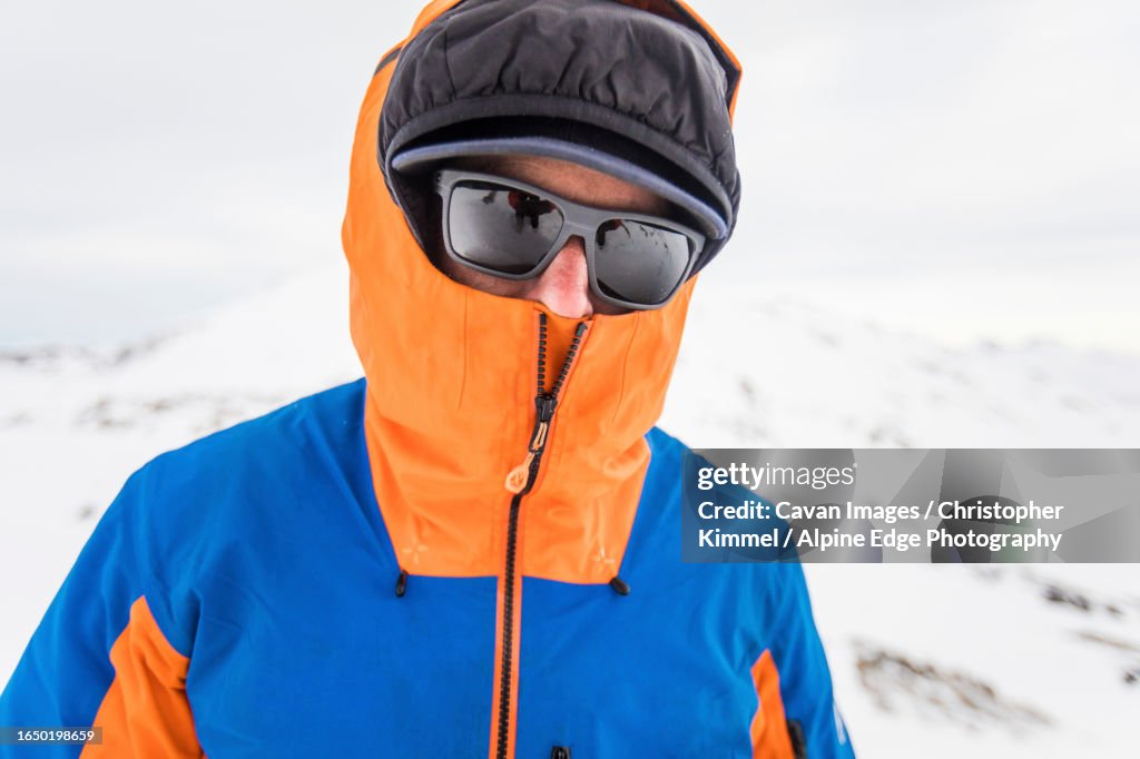 View of mountaineer staying warm with face and head covered