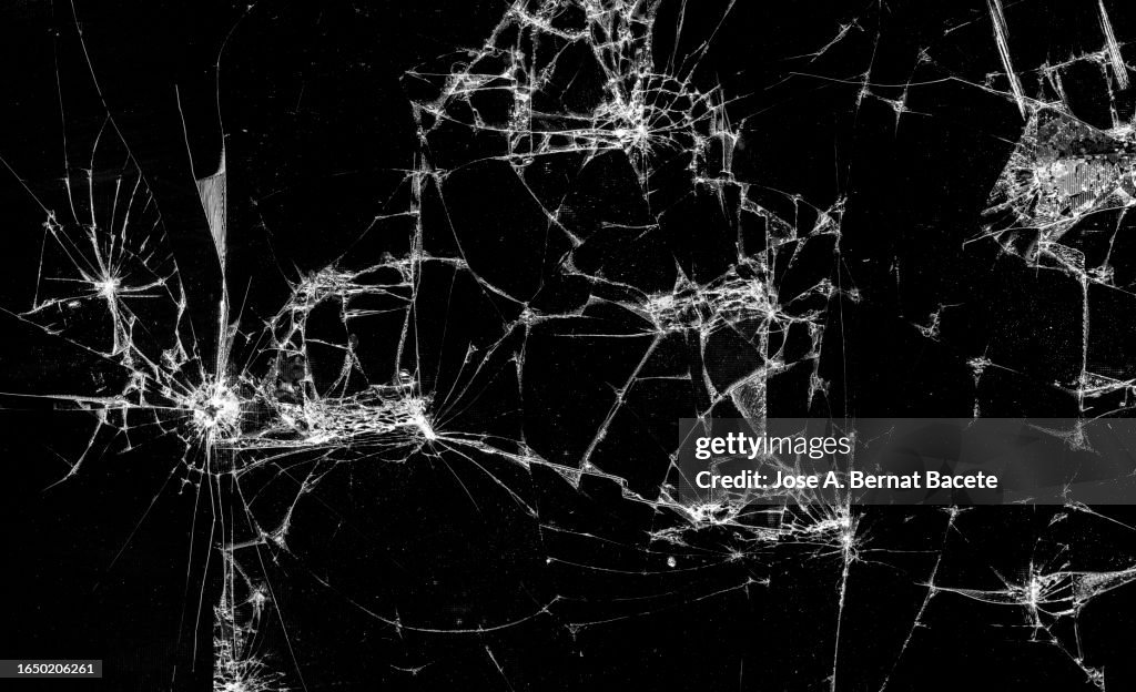 Full frame of a screen of a smartphone with broken glass.
