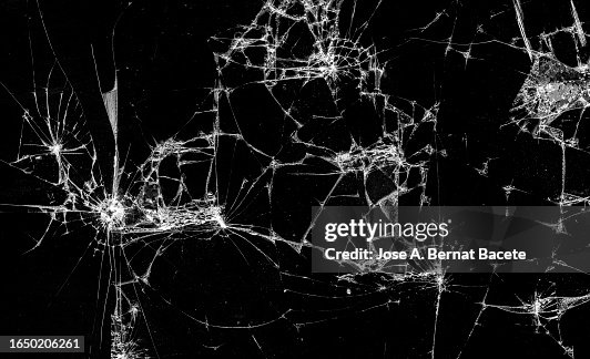 Full frame of a screen of a smartphone with broken glass. Full frame of a screen of a smartphone with broken glass.