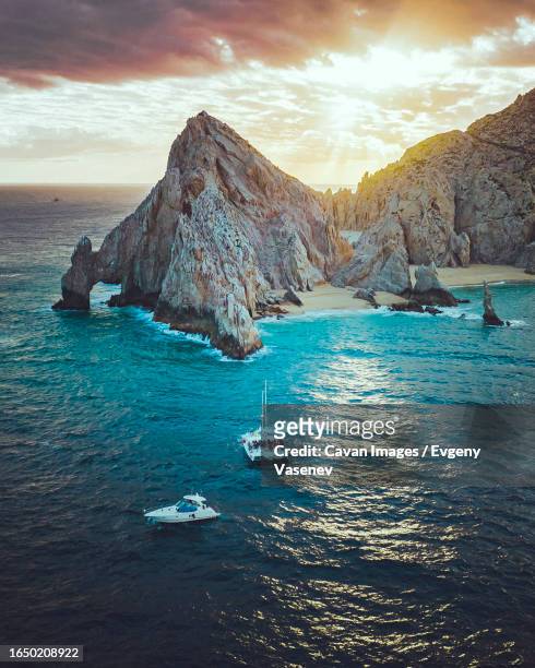 boats in the ocean near cabo san lucas, baja california - mexico stock pictures, royalty-free photos & images