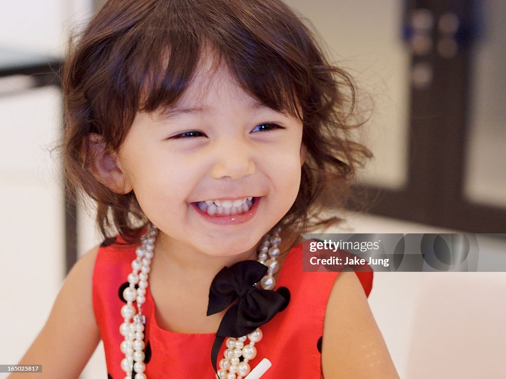 Toddler girl in formal clothes smiling