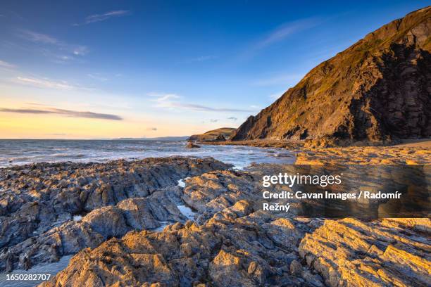 dramatic coast in aberystwyth at sunset - cardigan wales stock pictures, royalty-free photos & images